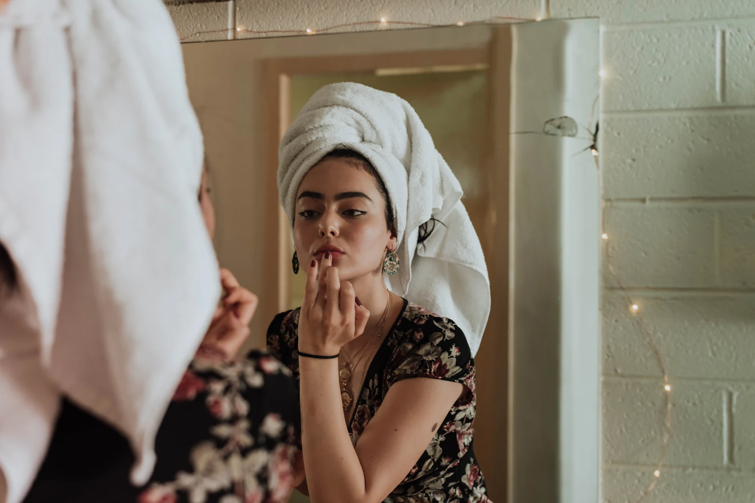 Applying makeup in a mirror at home