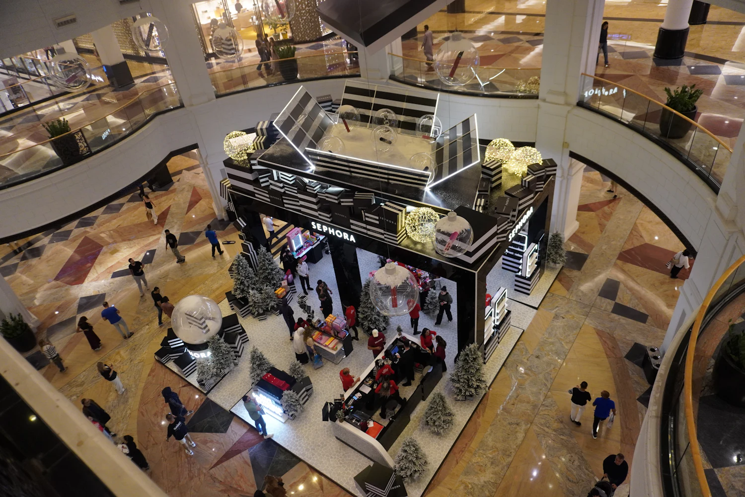 A busy Bangkok shopping mall atrium