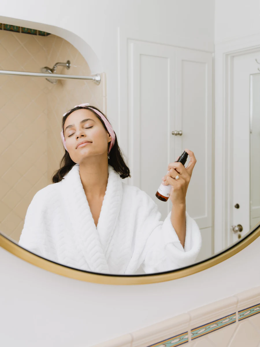 Morning skincare routine in front of a bathroom mirror