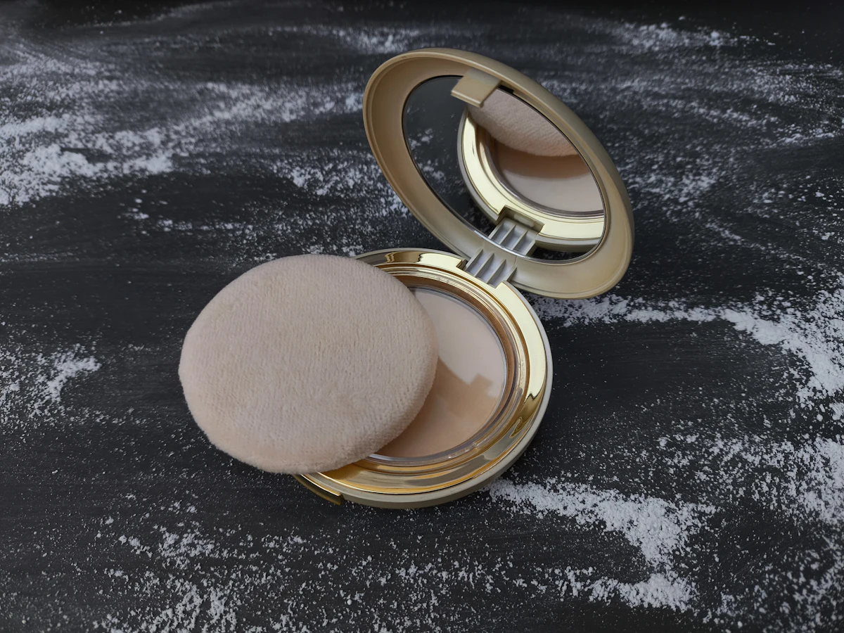 An open cushion compact with its puff