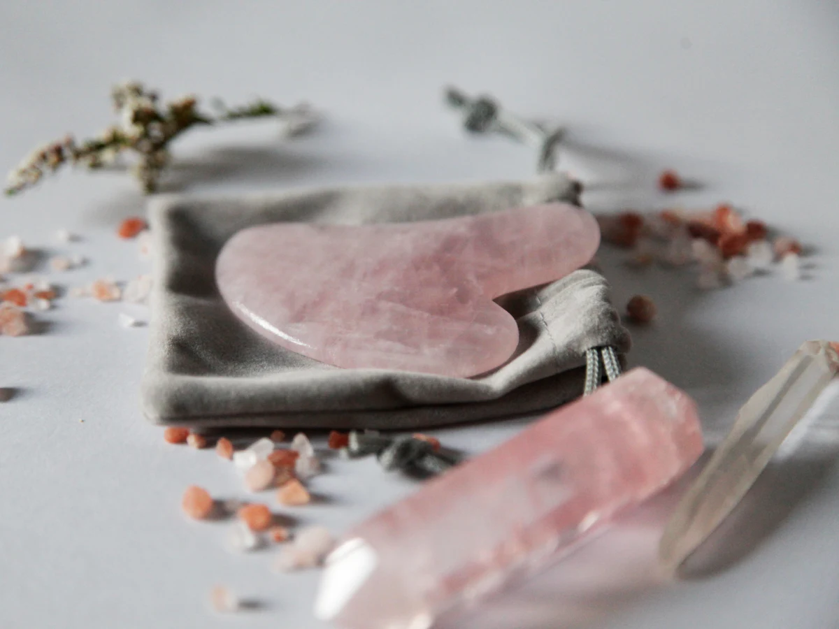 A rose quartz gua sha and roller