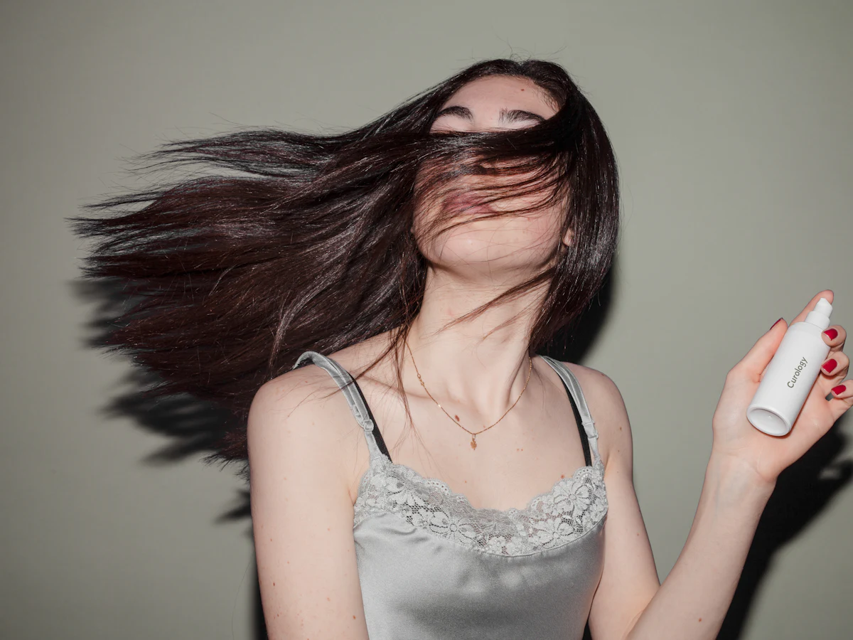 Spritzing a leave-in mist through hair
