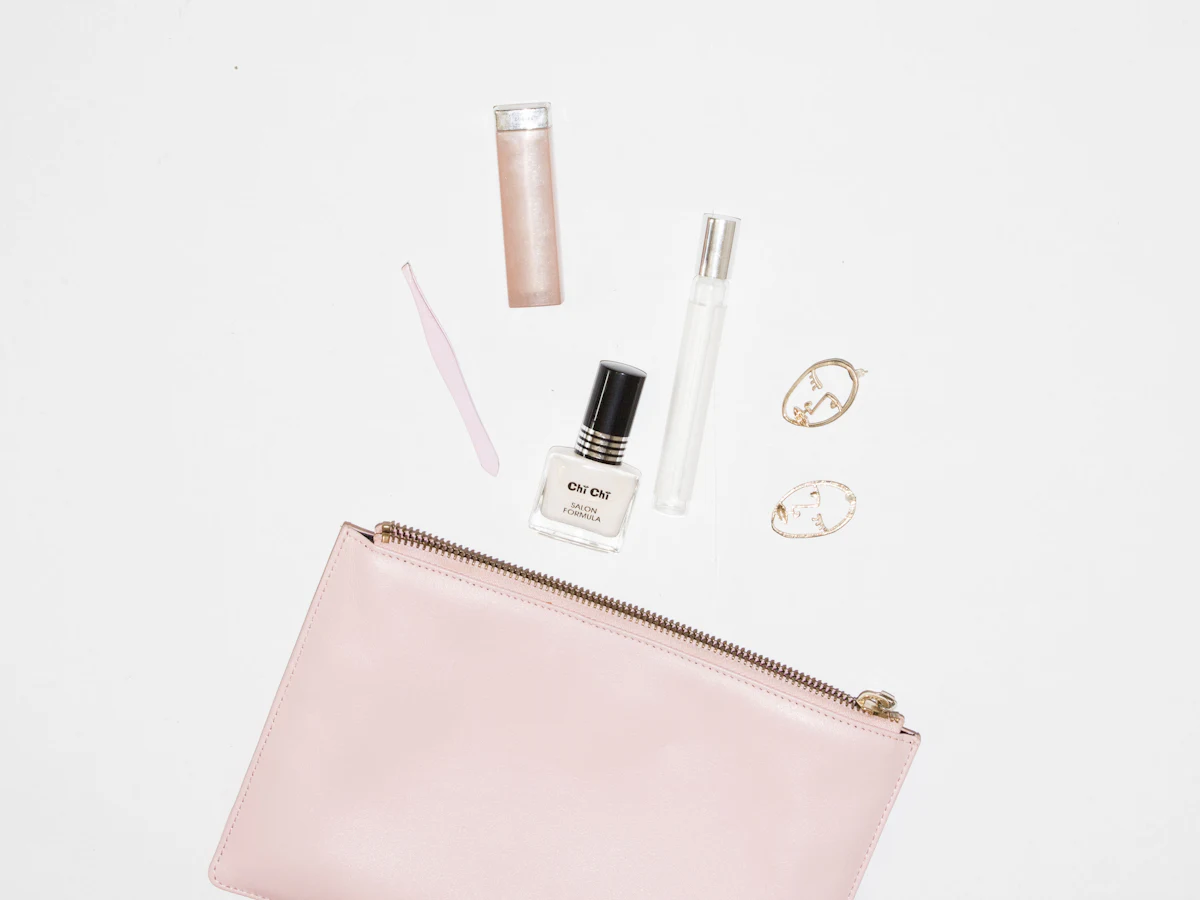 A pink pouch with travel-size beauty minis