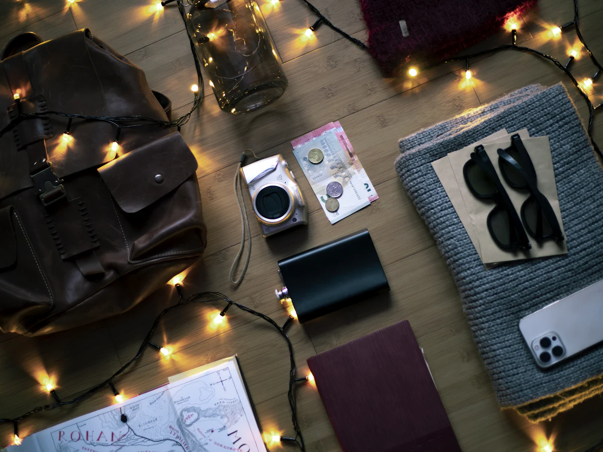 Market-day essentials laid out: bag, sunglasses, phone and travel bits