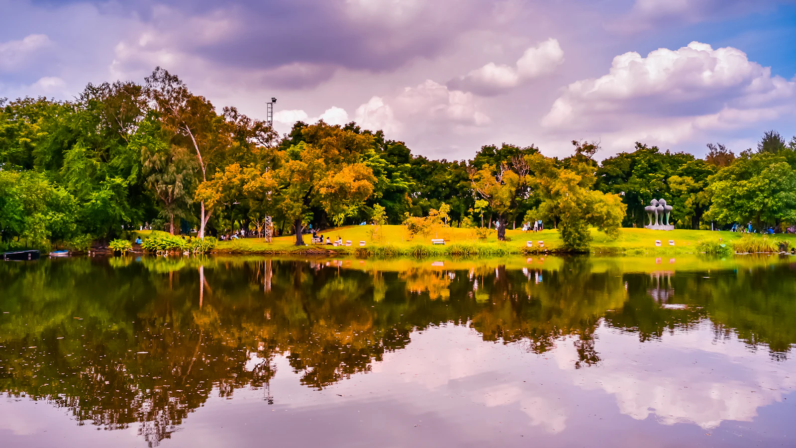 Trees reflected in the lake at a Bangkok park